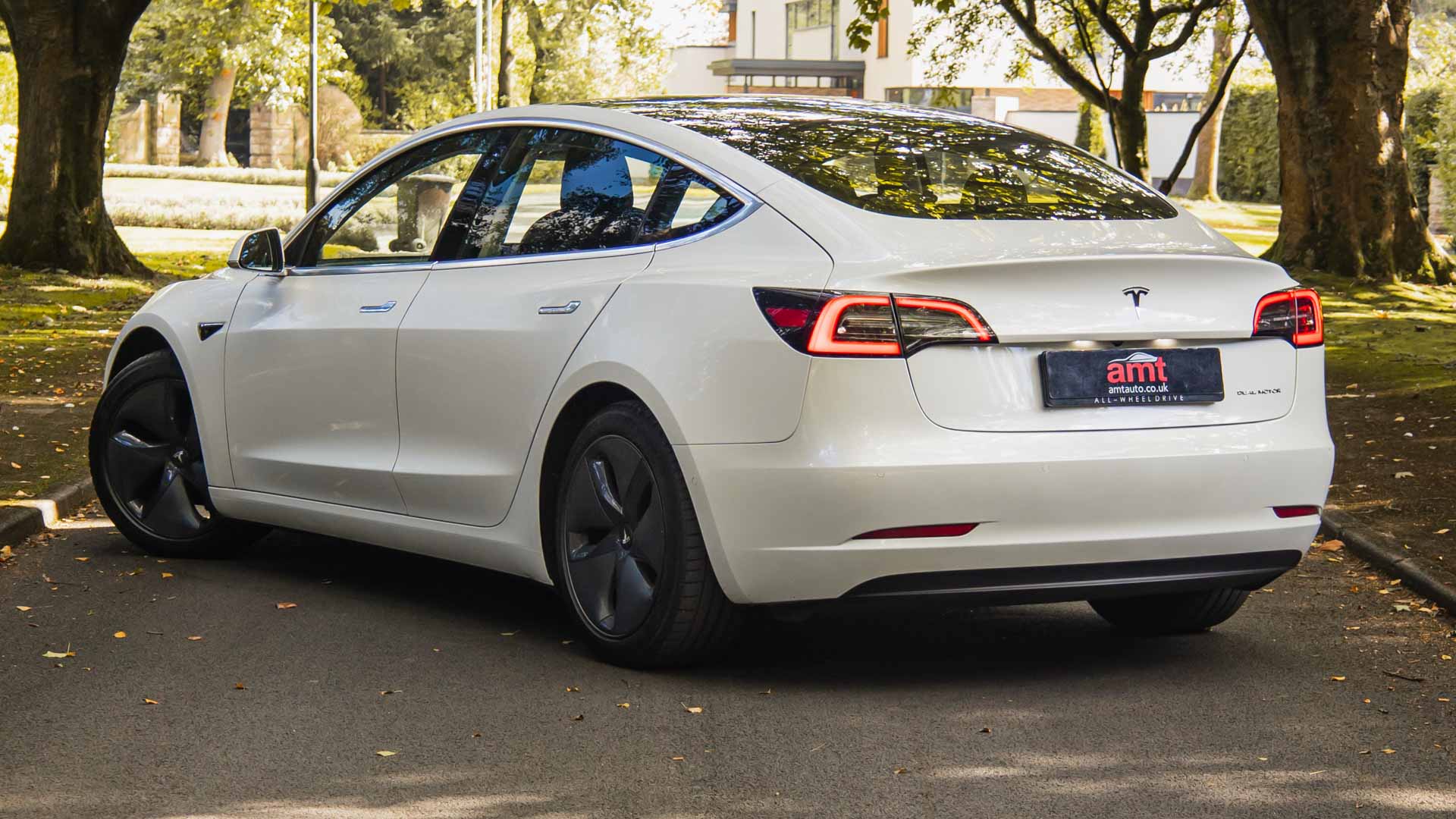 Rear view of a used Tesla Model 3 electric car available for lease from AMT Auto
