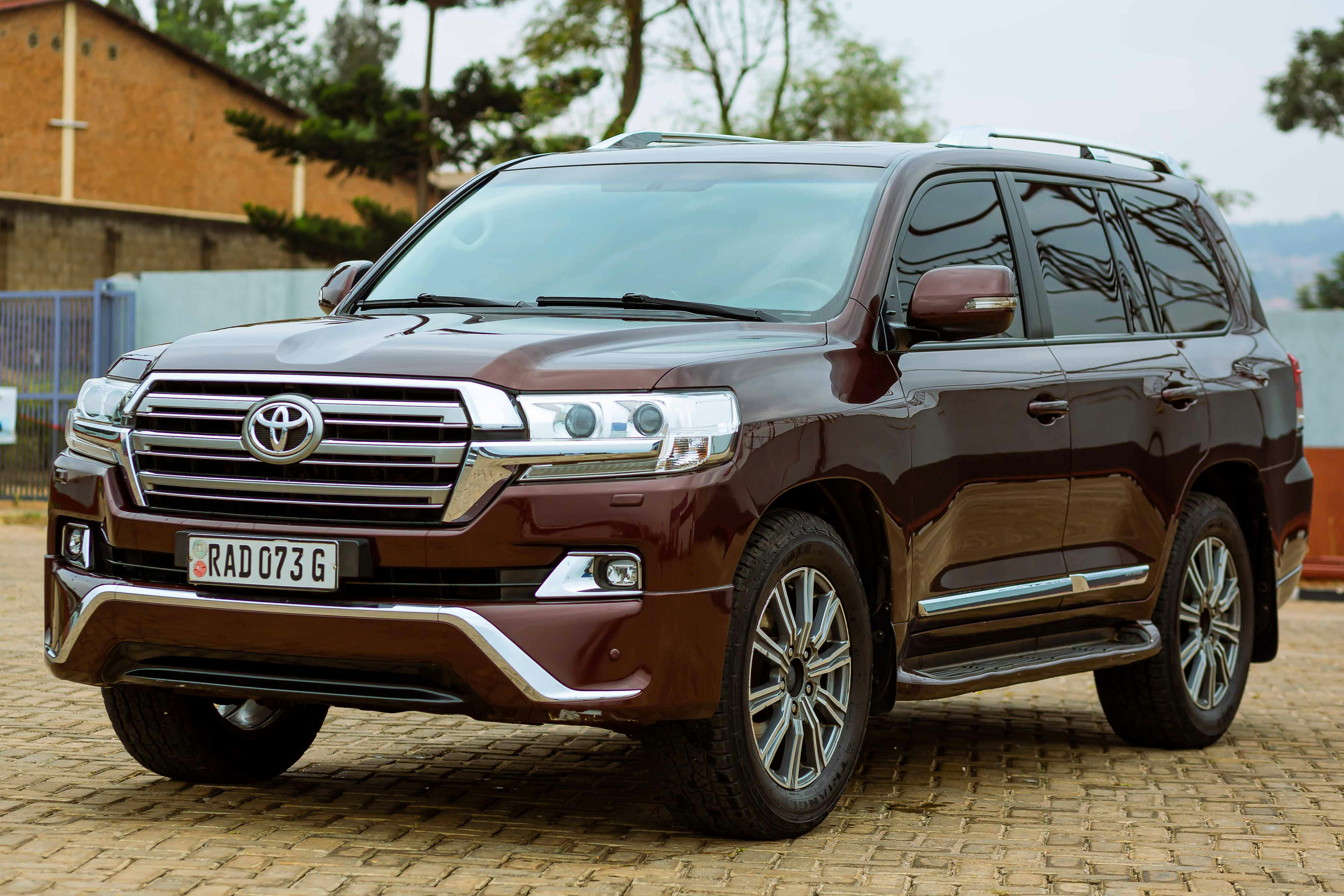 A Toyota Land Cruiser conquering a steep, uneven path, emphasizing its powerful build and advanced off-road capabilities. The vehicle boasts a robust frame, high ground clearance, and durable tyres, making it perfect for tackling challenging terrains and long-distance adventures.