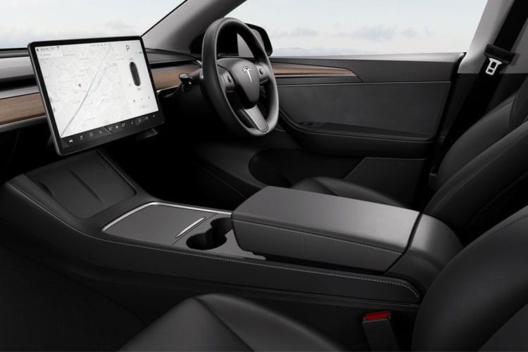 Interior view of an electric car equipped with self-driving technology, featuring black seats.