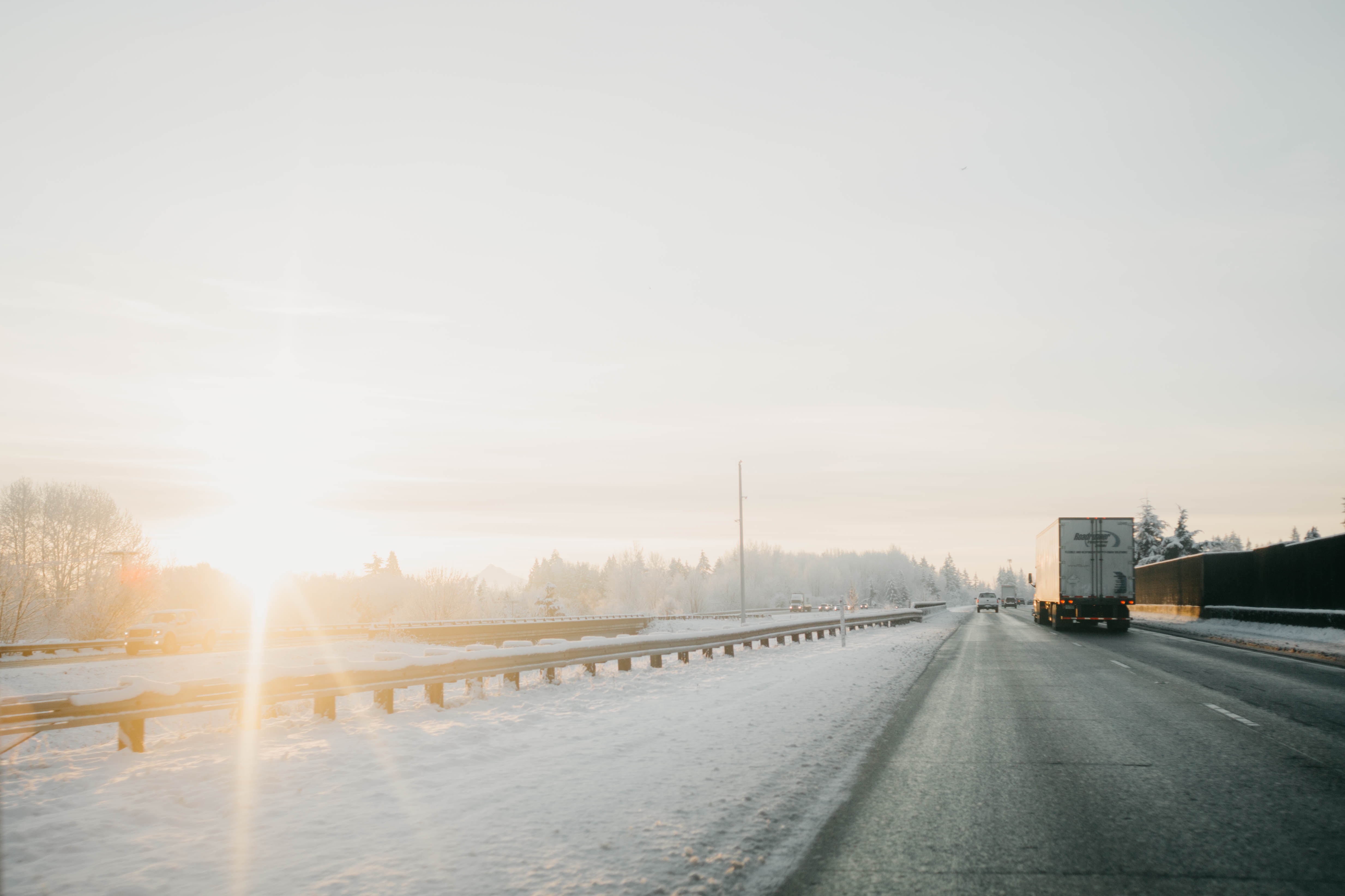 Icy roads with sun setting in the distance.