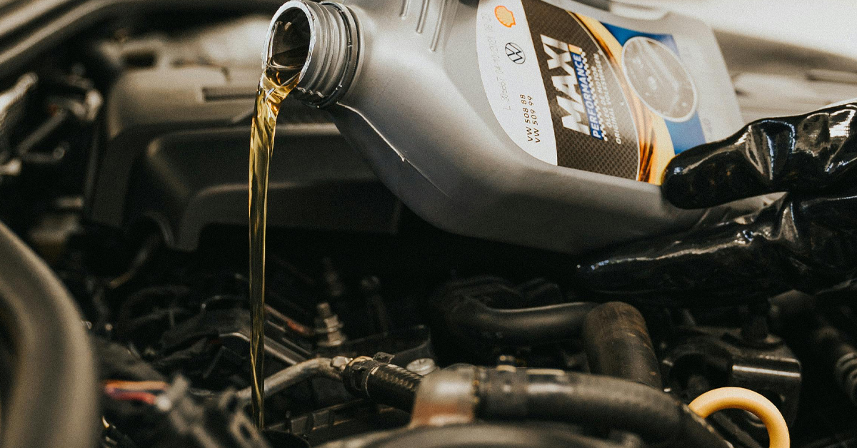 An image showing oil being poured into a car