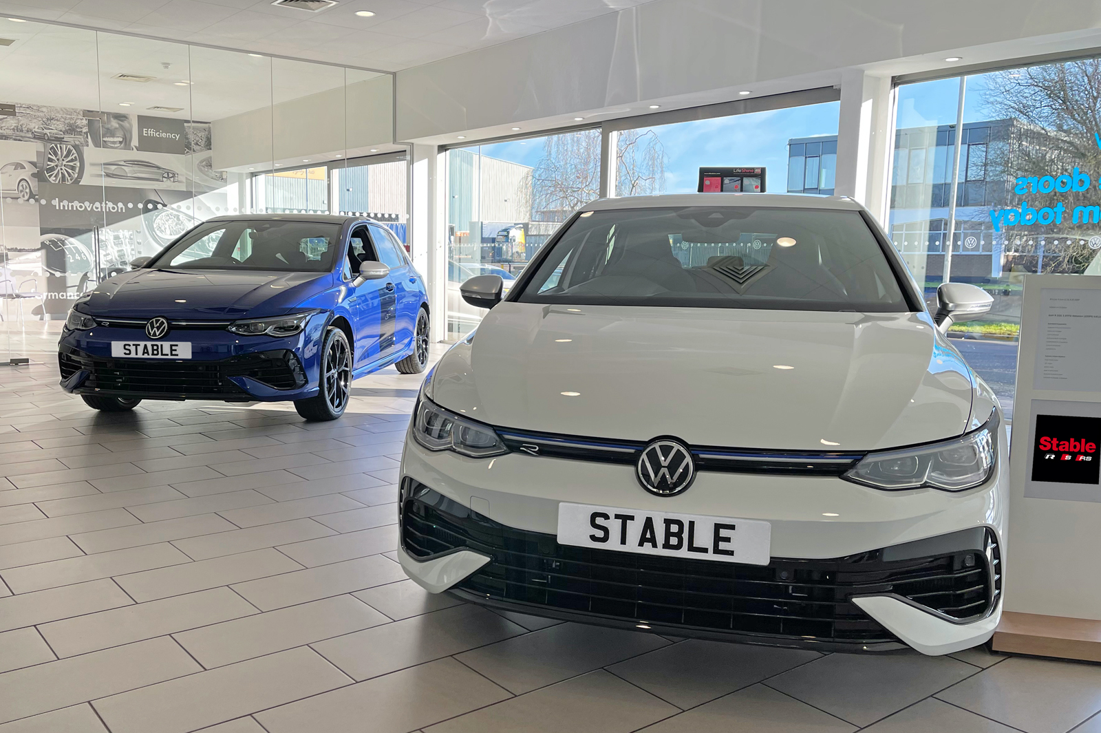 An image of showing two Volkswagen Golf R Mk8 in a car dealership 