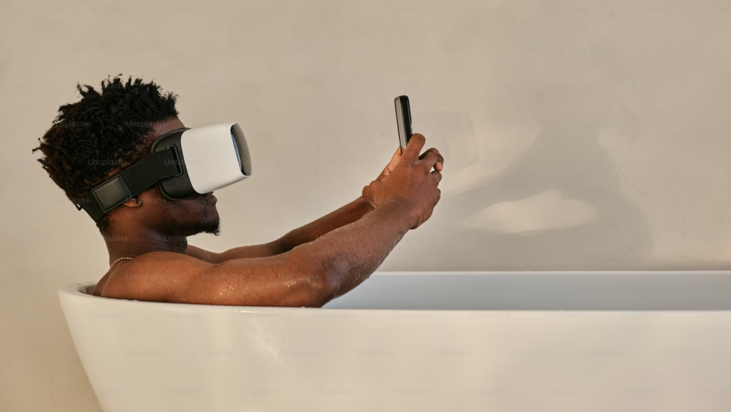 A picture of a man in the bath with a VR headset on