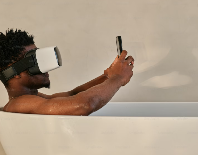 A picture of a man in the bath with a VR headset on