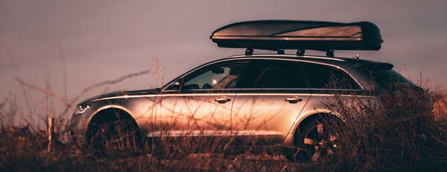 Silver estate car with roof box