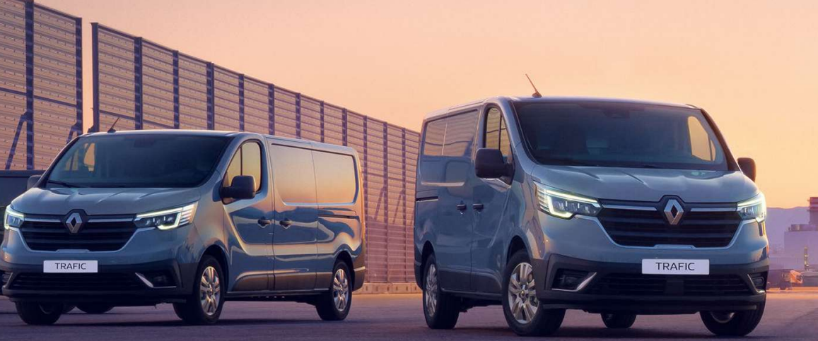 A picture of the front lights of two new Renault Trafic panel vans