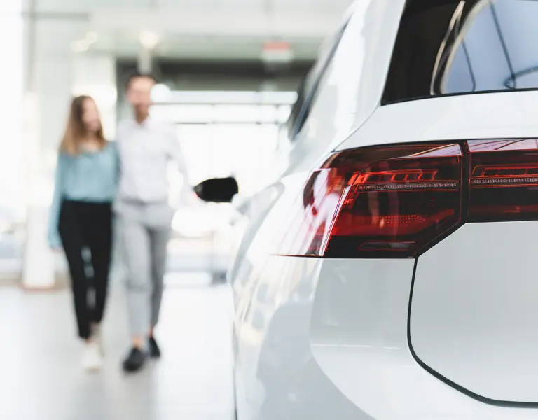 Couple walking towards white car
