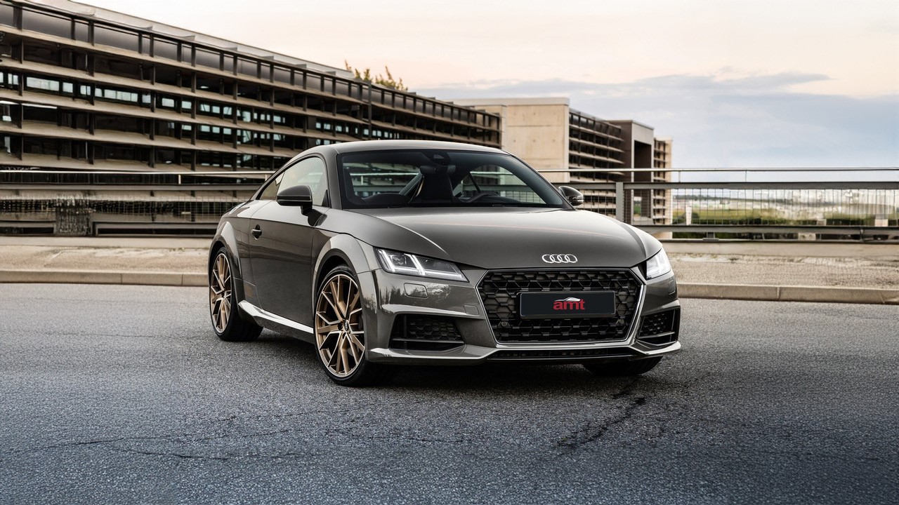 Grey Audi TT coupé parked on an urban rooftop, highlighting its sleek and sporty design.