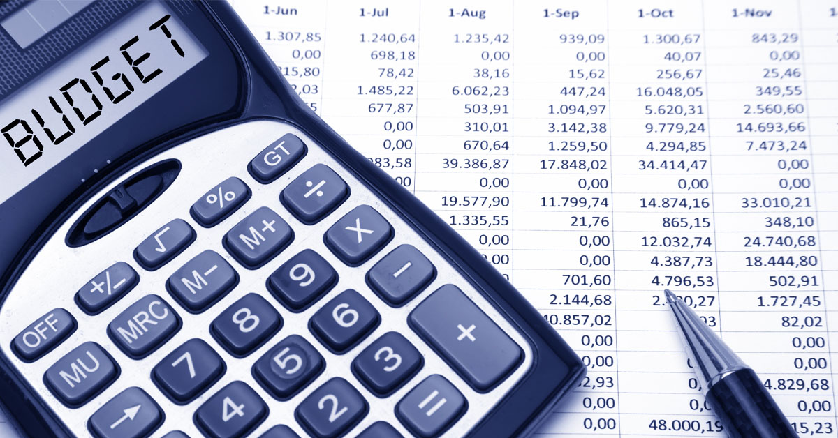 An image showing a calculator and budget sheet