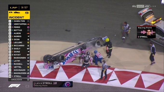 Lance Stroll is helped out of his Racing Point car by Dr Ian Roberts and the marshalls after a roll.