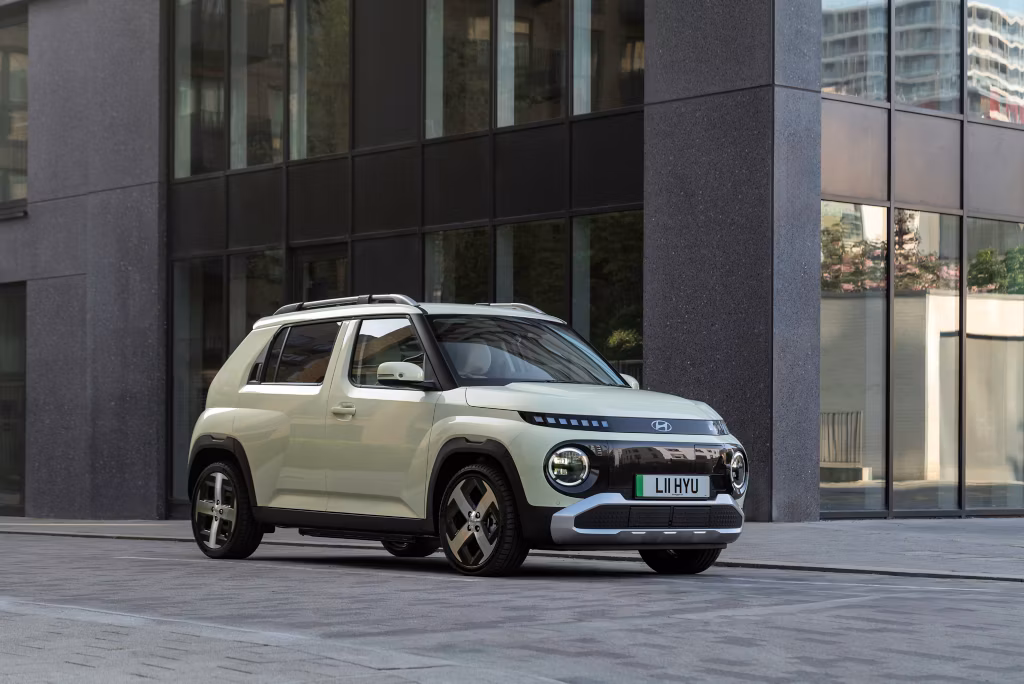 Front corner shot of the Hyundai INSTER in a city setting. 