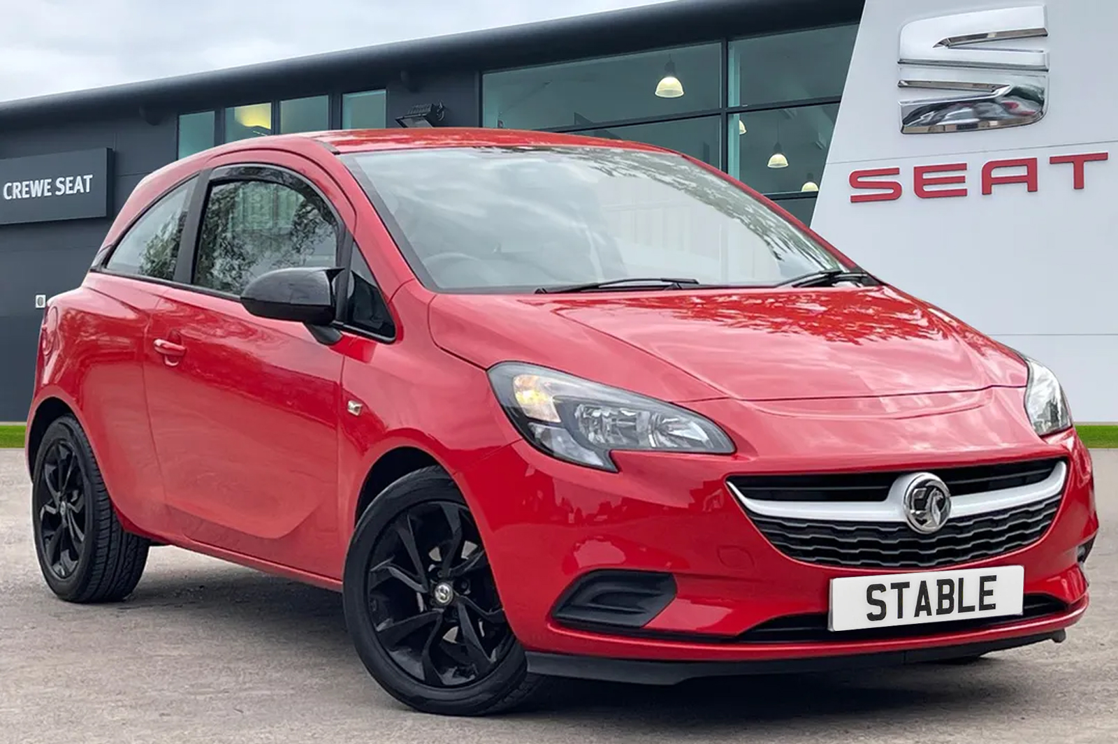 An image of a 2015 Vauxhall Corsa Hatchback in Brilliant Lava Red paint