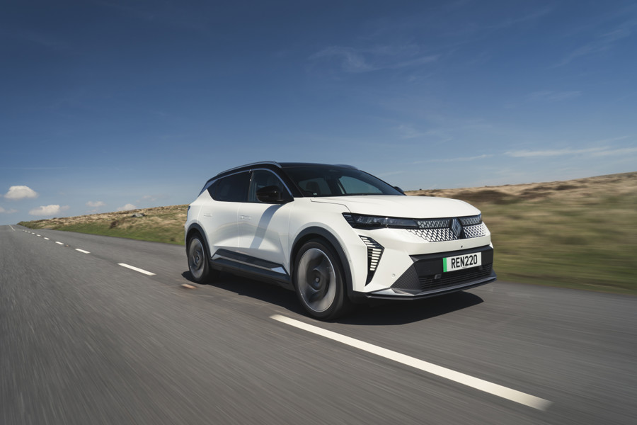 The Renault Scenic E-Tech driving down a country road.