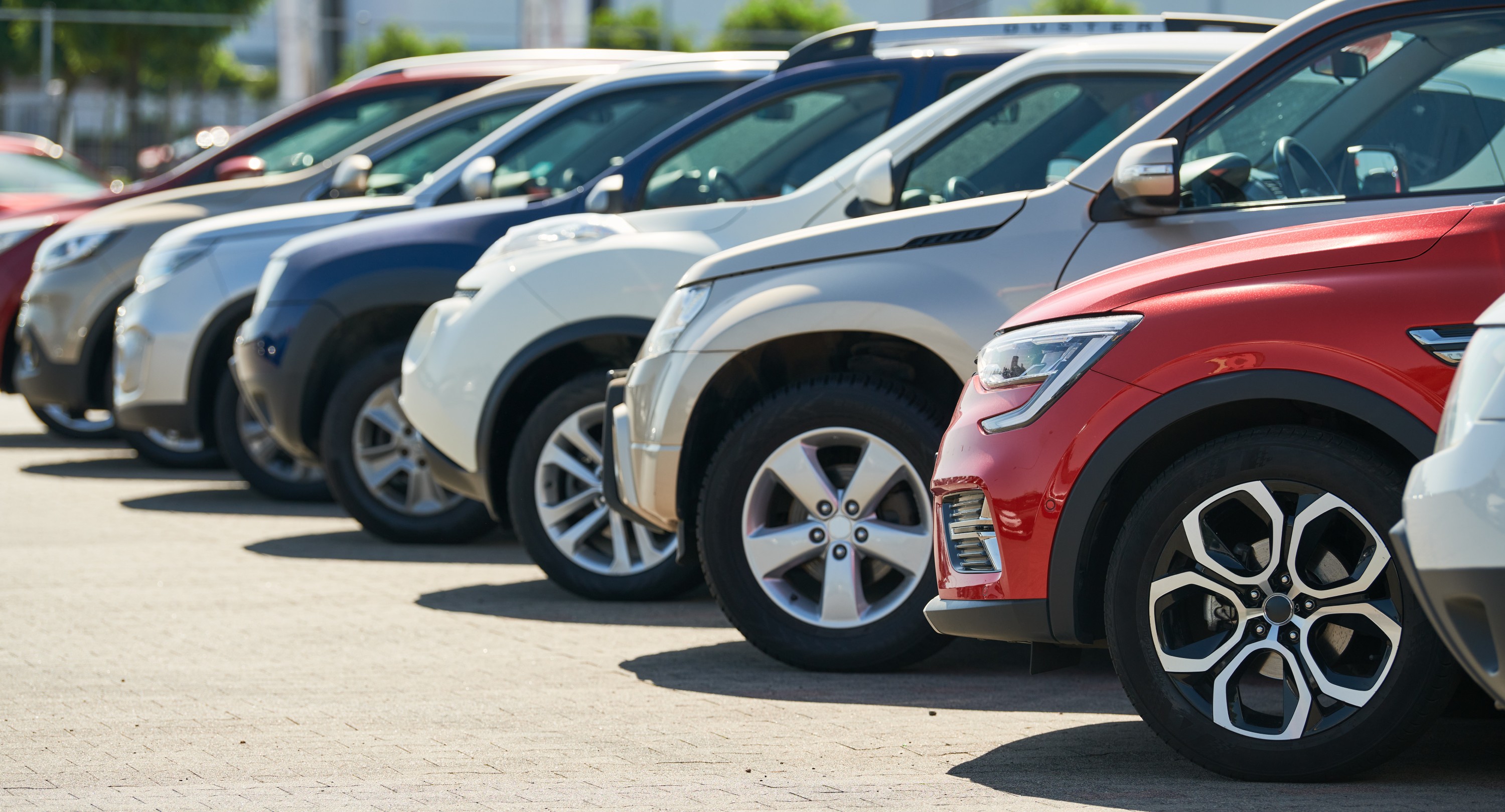 Multiple coloured cars in parking area