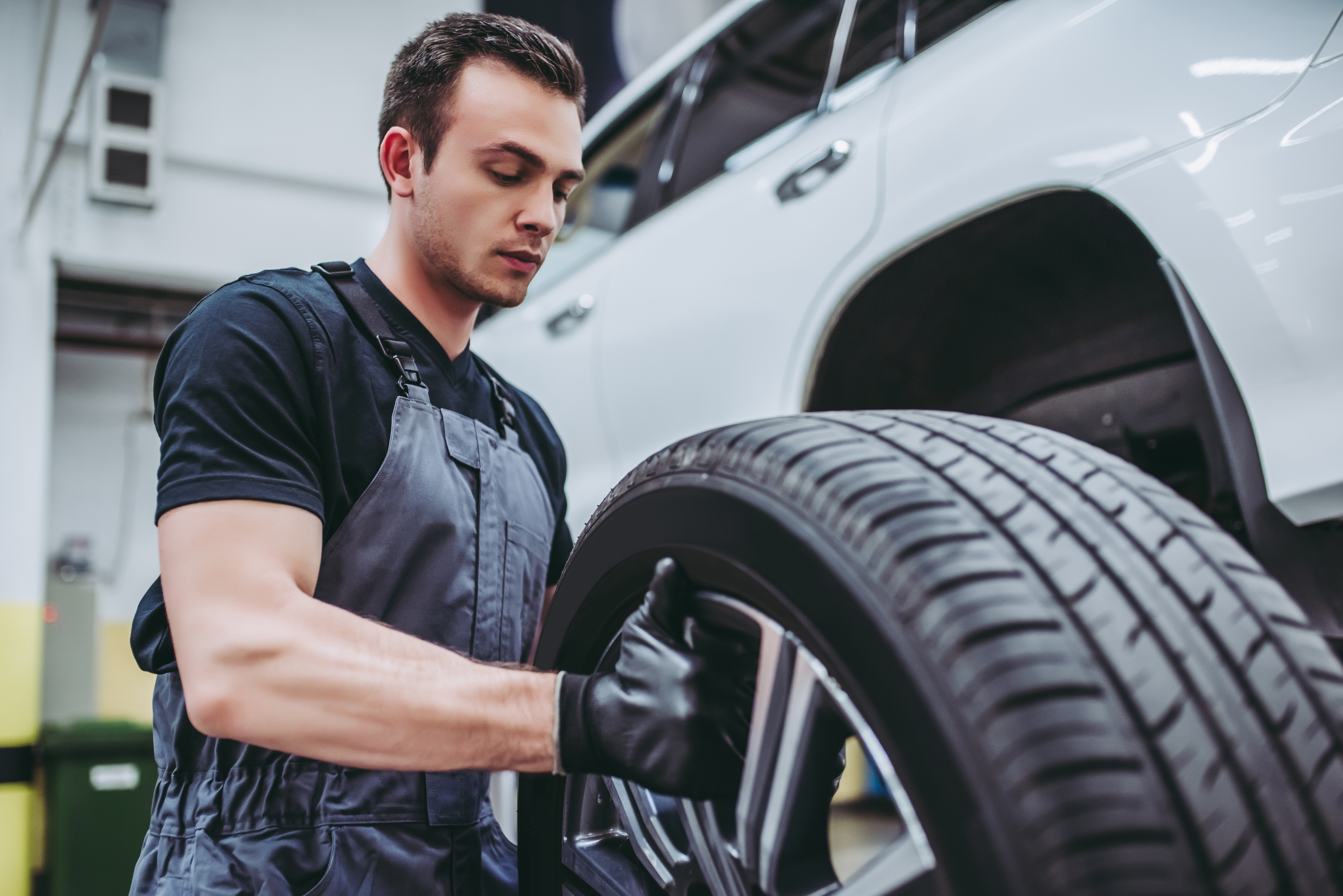 A mechanic doing maintenance on a car.