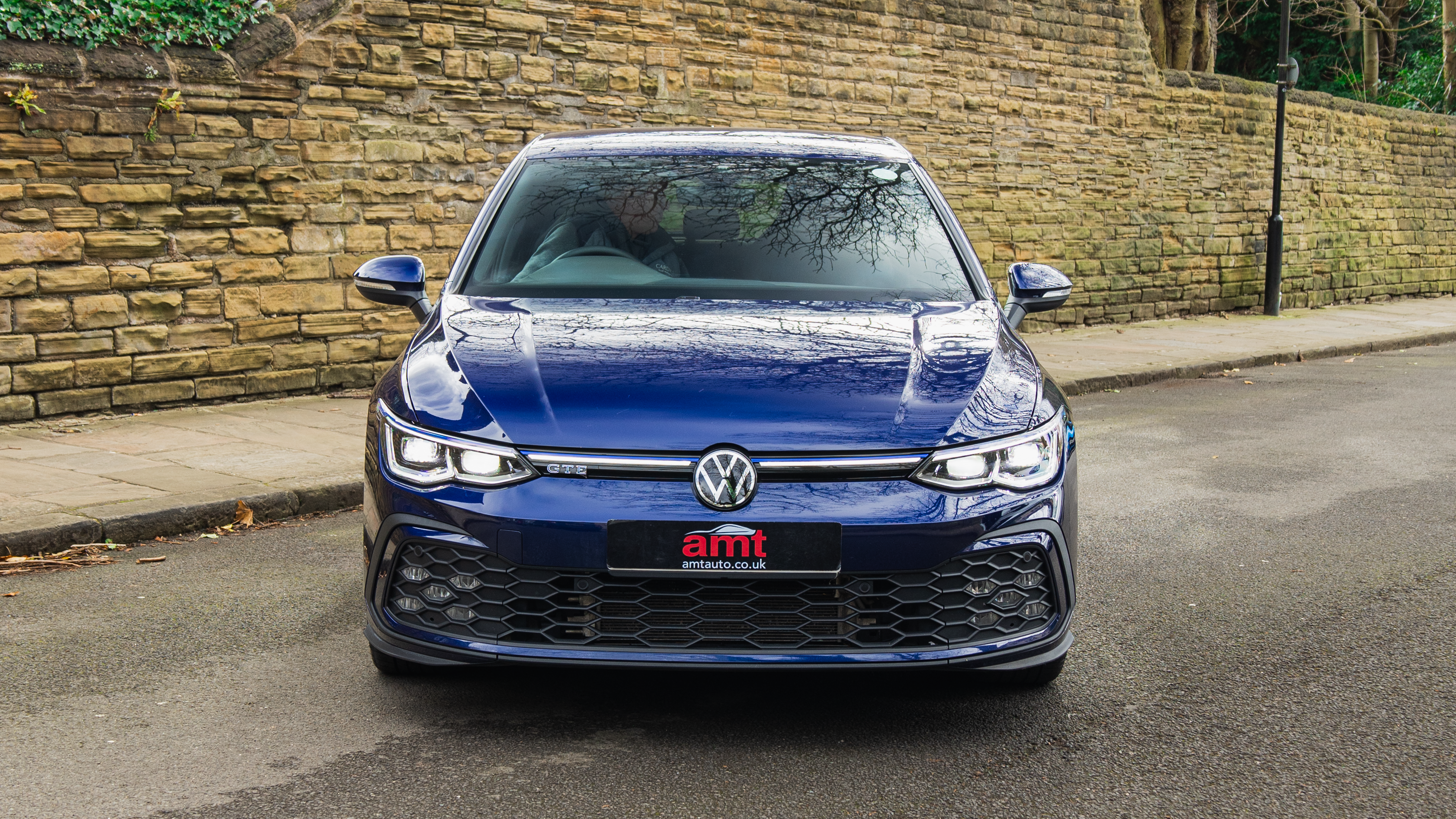 VW Golf GTI in Lapiz Blue parked on a quiet street, available from AMT Auto’s UK VW Golf lease deals with sporty styling