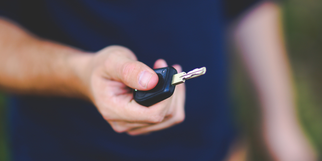 holding car key