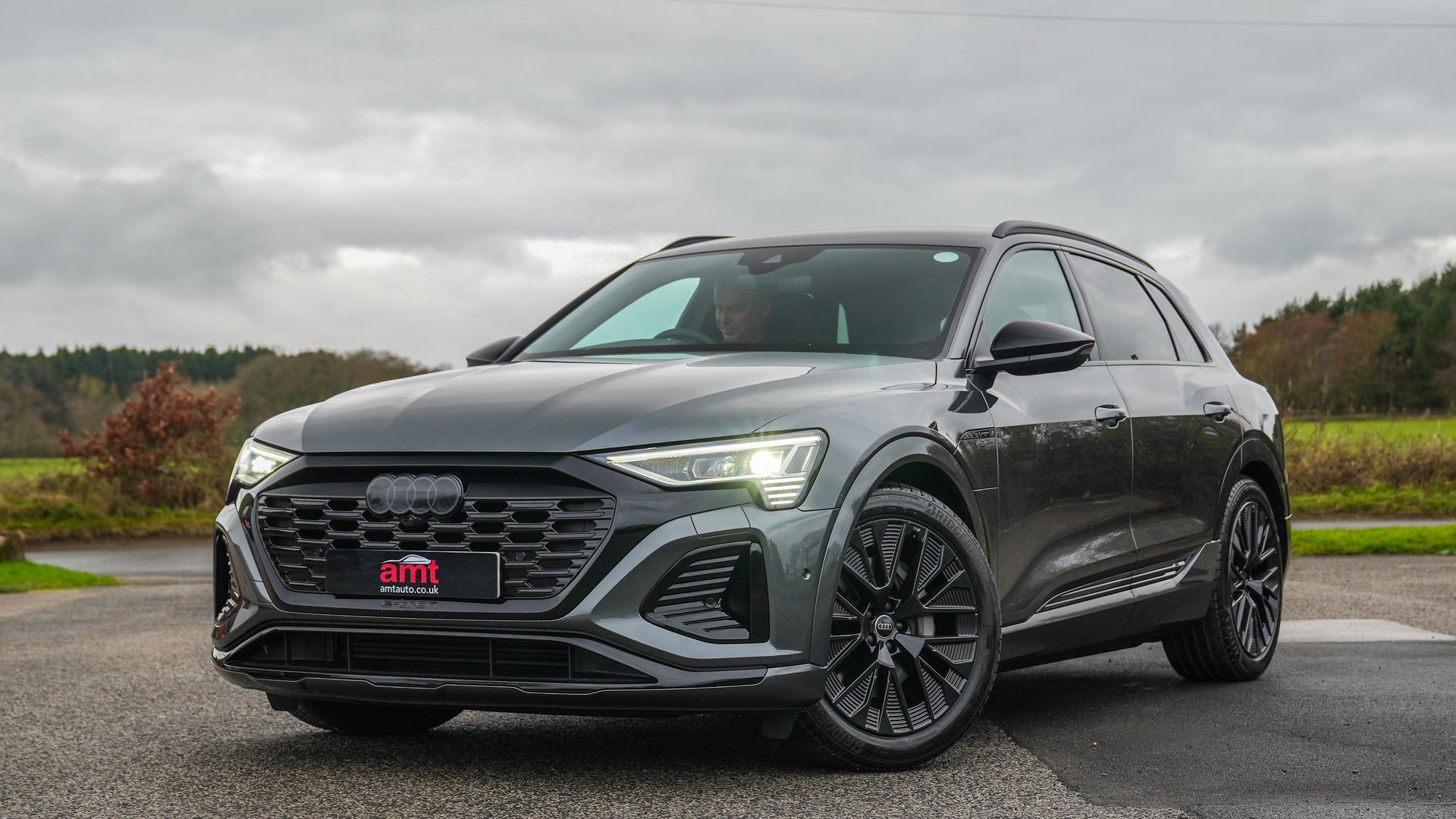 Grey Audi Q8 e-tron SUV featured in AMT Auto’s review of its electric performance, range and tech.