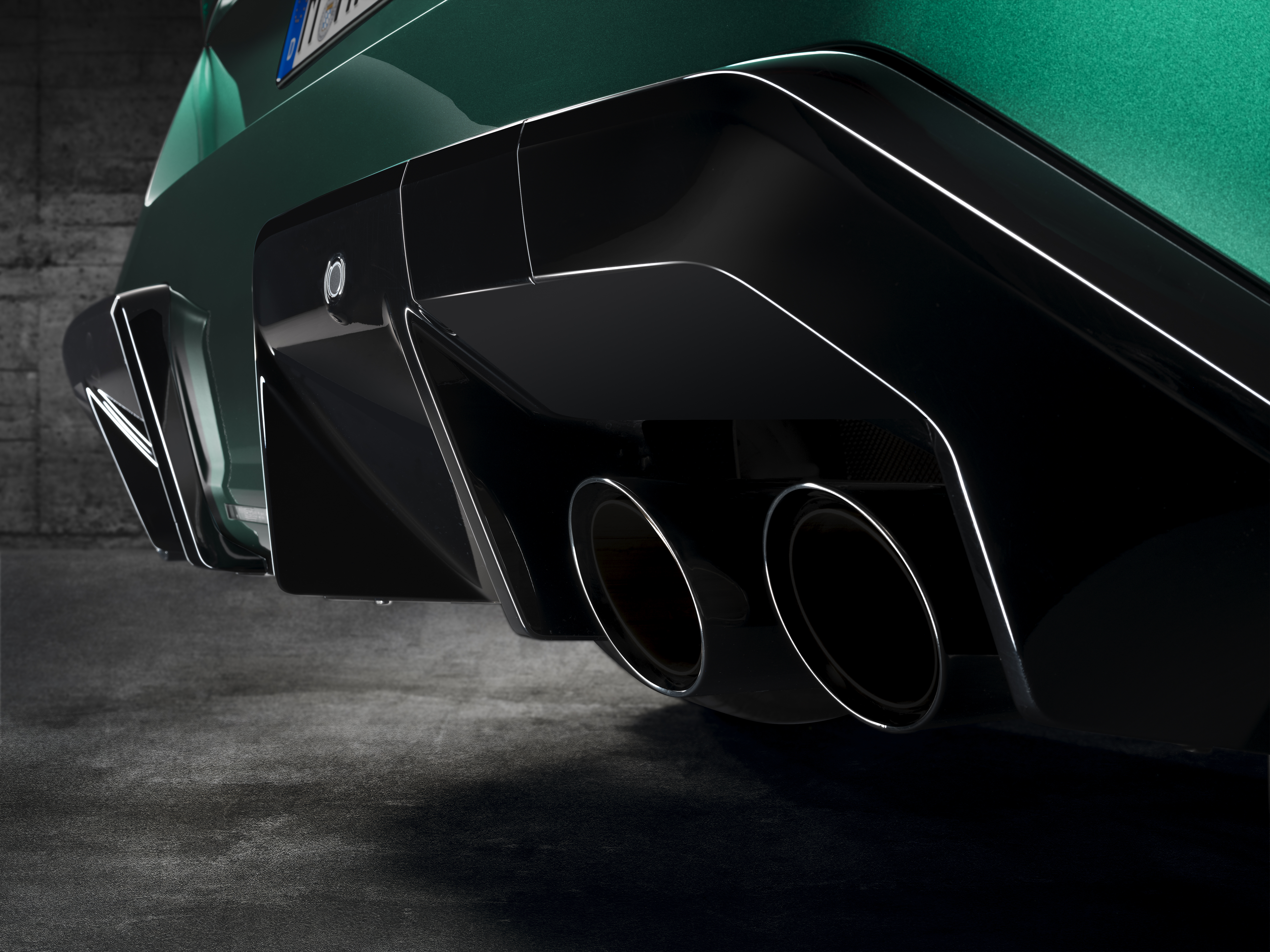 Close-up photo of the quad exhaust system on a BMW M5,