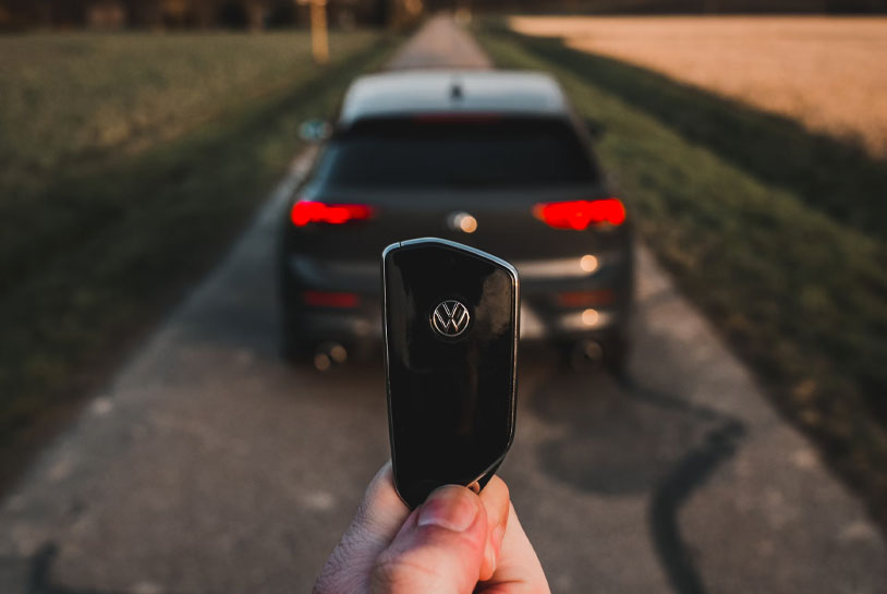An image showing a person holding the key of a Volkswagen Golf