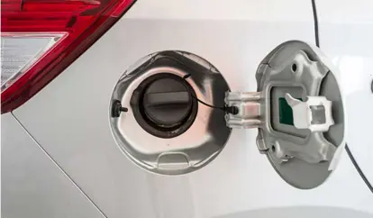 A silver car's open fuel cap