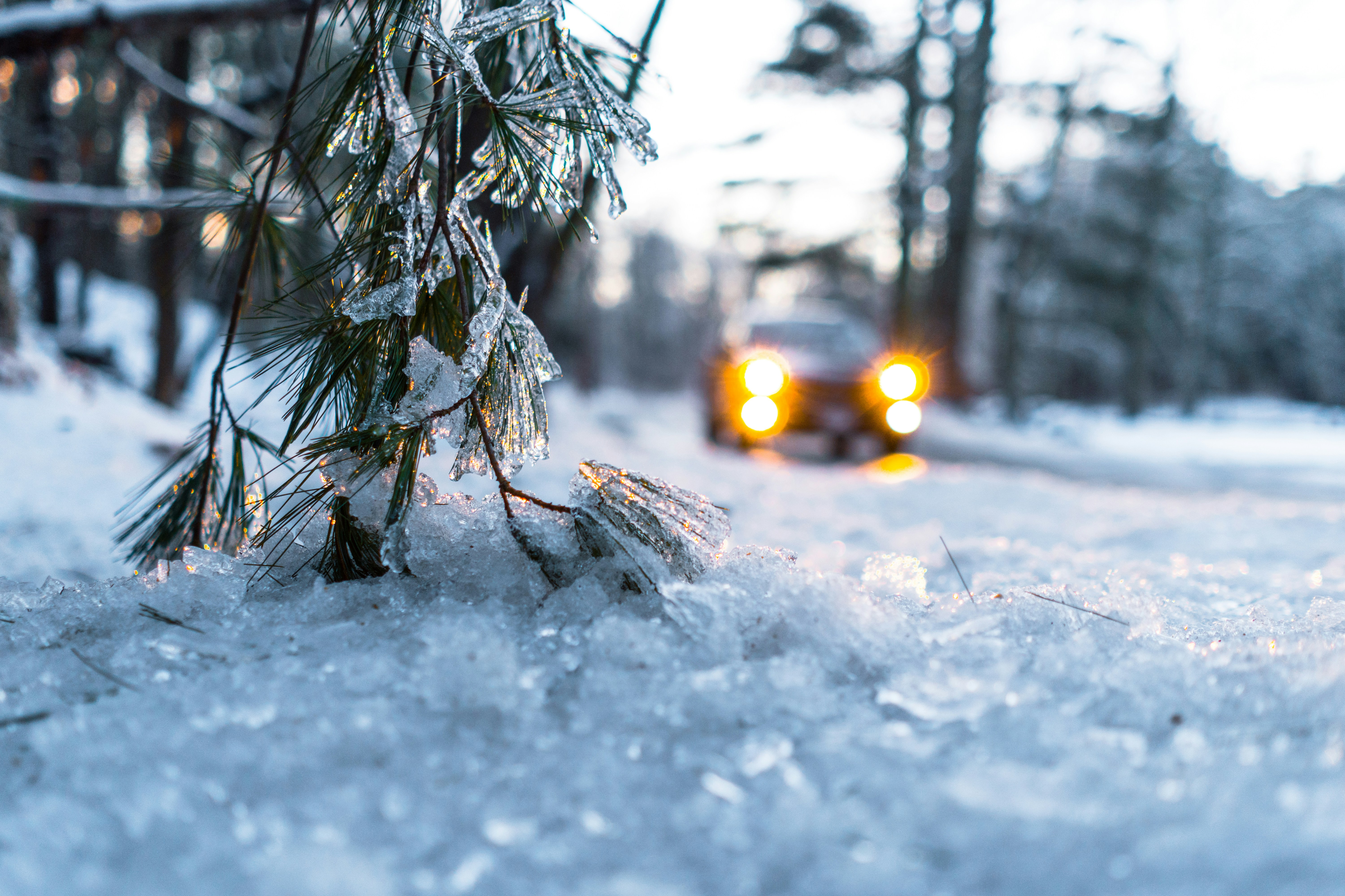 Frozen weather with cars headlights on.