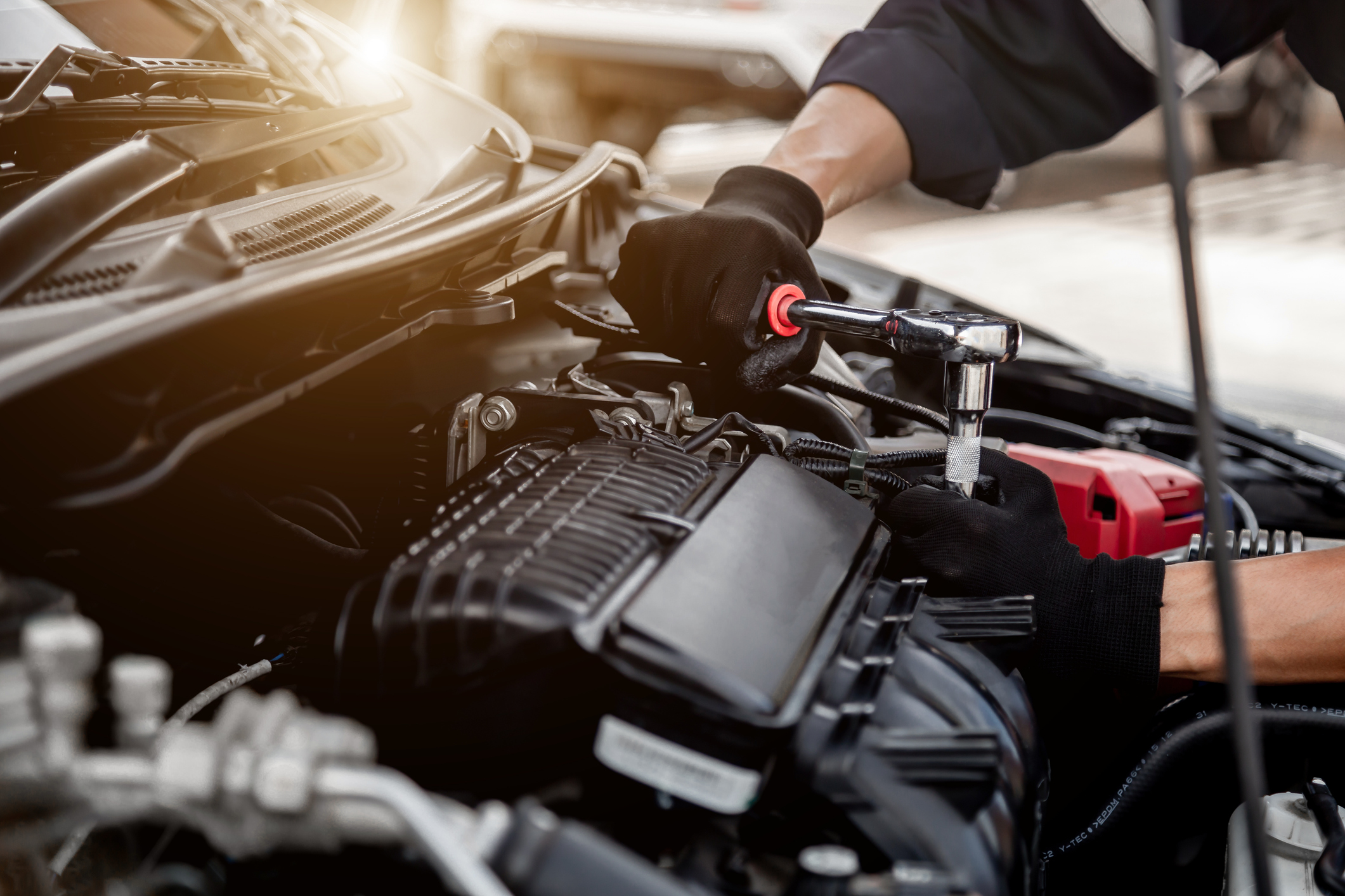 person performing maintenance on car