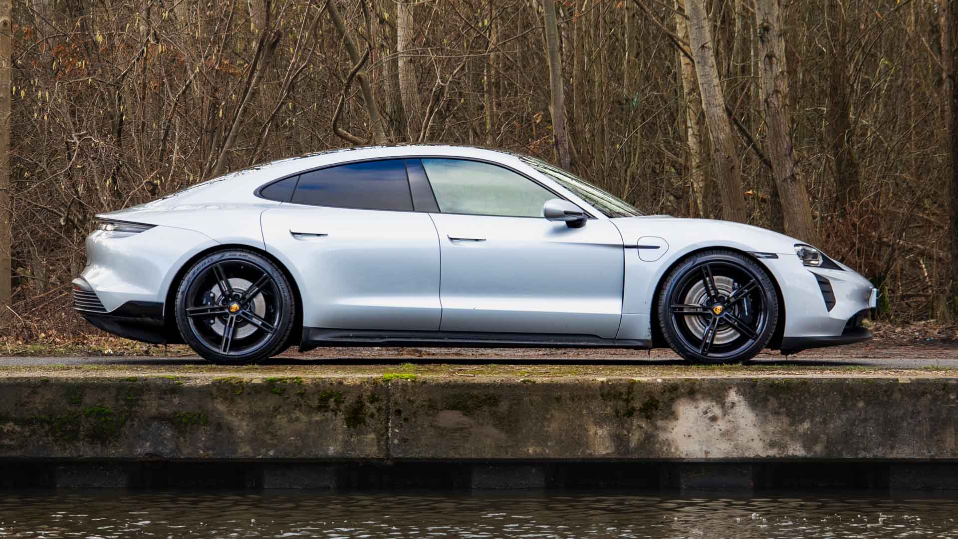 Side profile of a Porsche Taycan, highlighting its sleek design and premium electric appeal for lease.